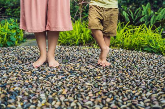 Kids standing on pebble paving